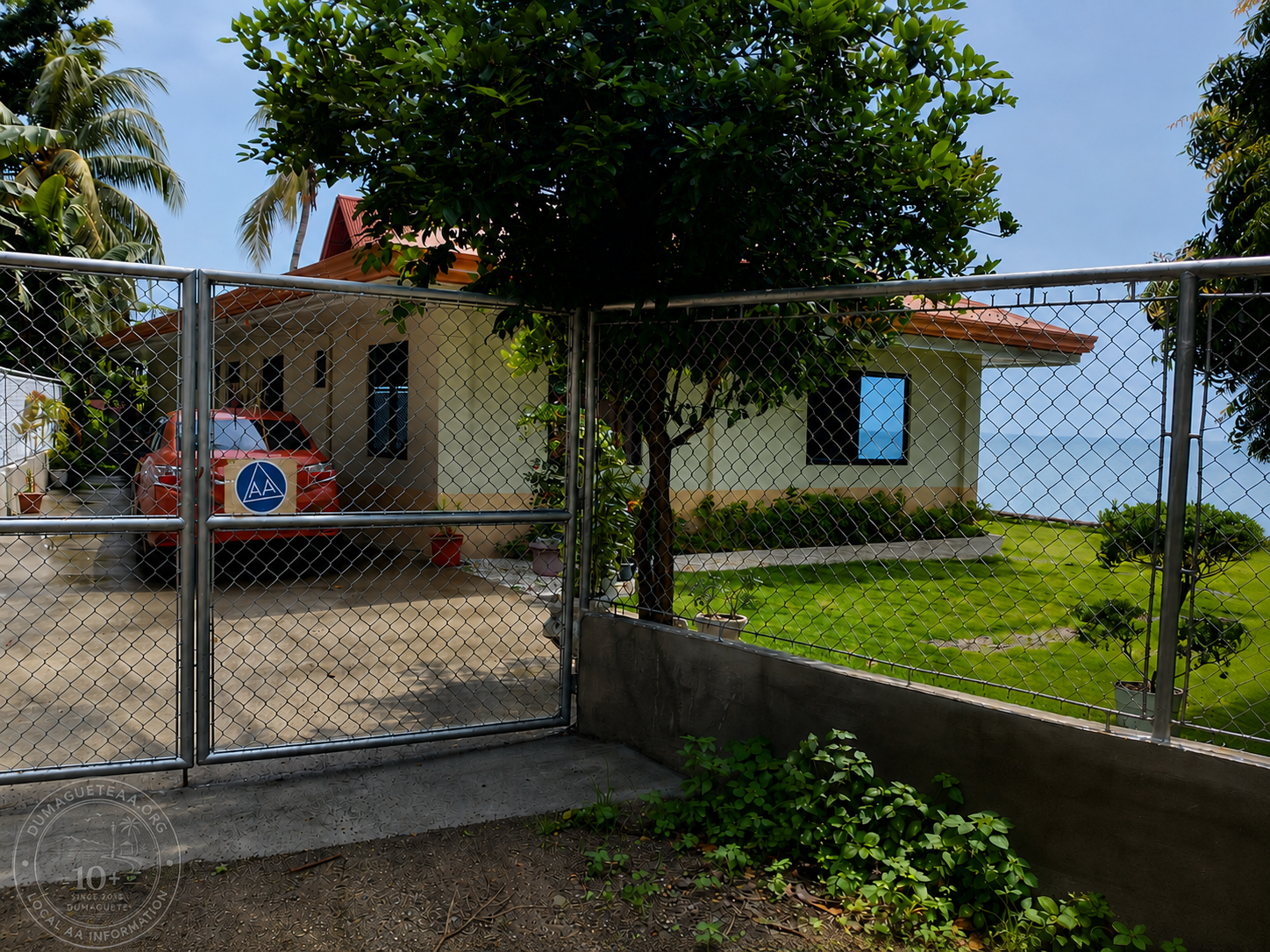 Entrance to the Saturday Live AA Meeting at a private beachfront residence in Bacong, Negros Oriental, with an AA sign on the gate